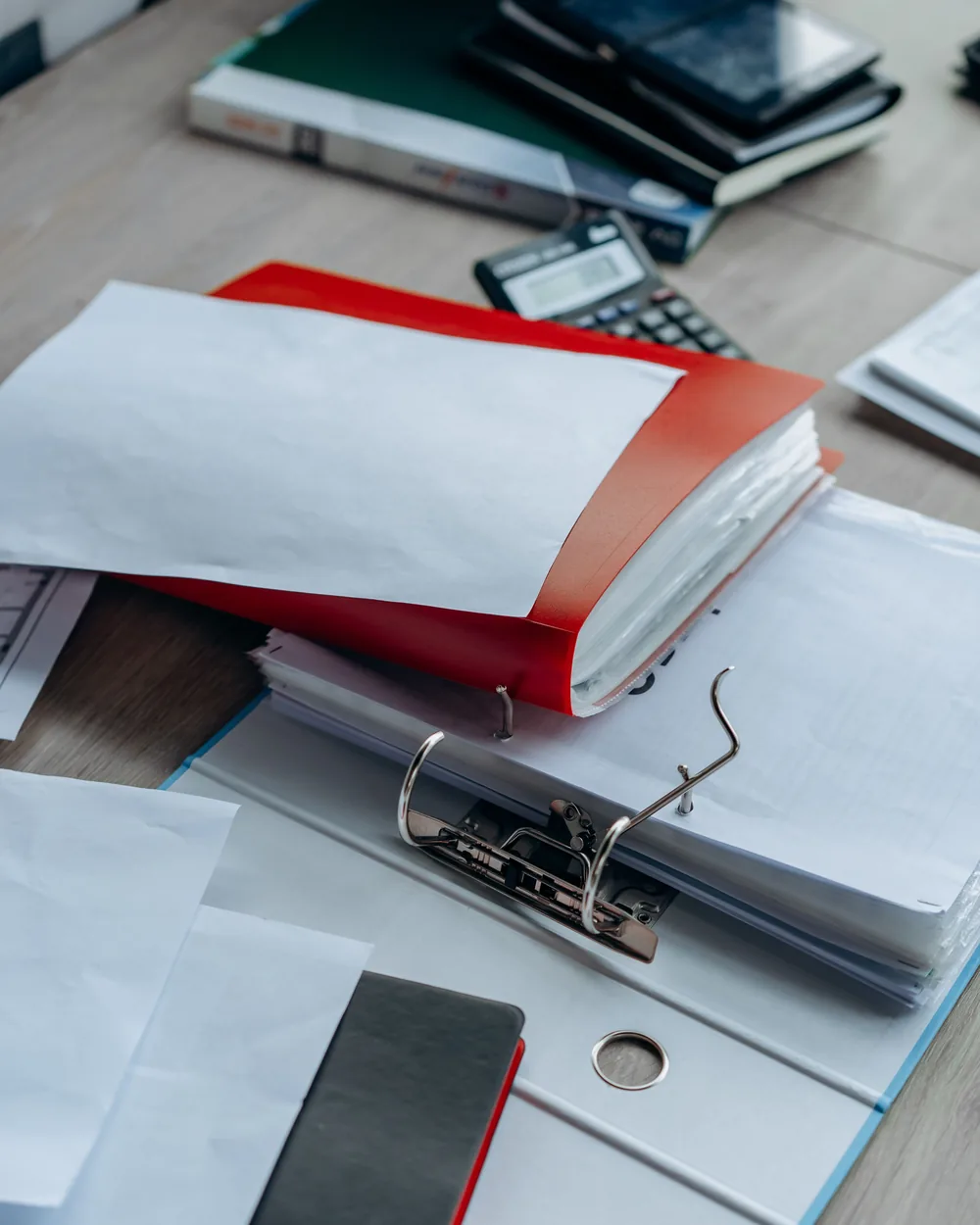 Binders and paper records organized on an office table
