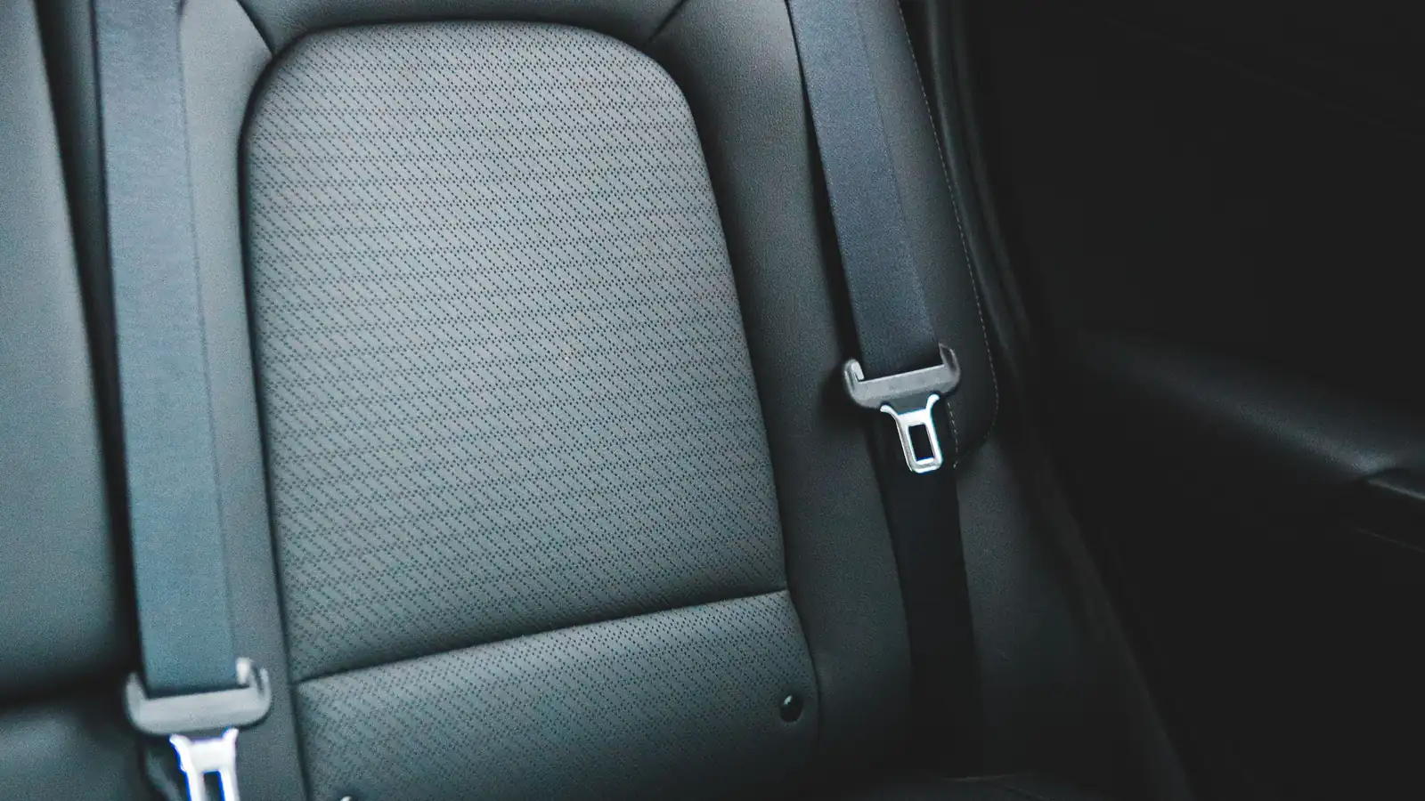 Empty modern vehicle seat with its seat belt visible