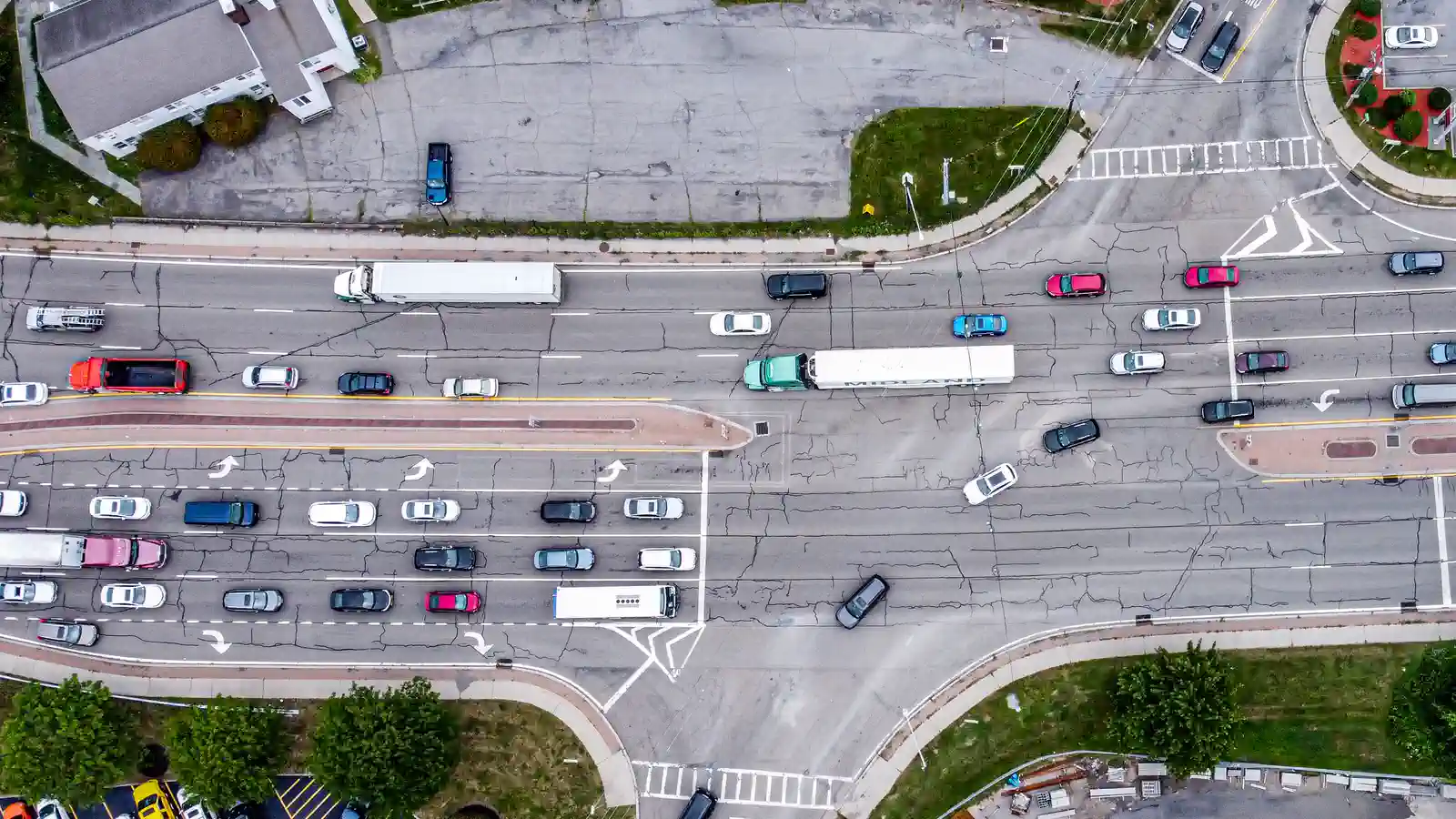 Aerial view of cars and trucks moving through a busy multilane road junction
