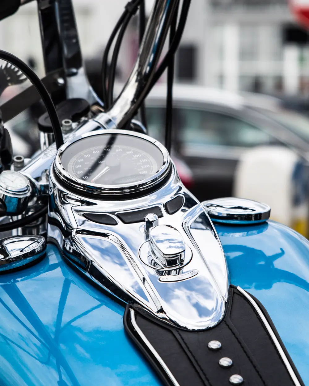 Blue motorcycle with visible speedometer and ignition controls