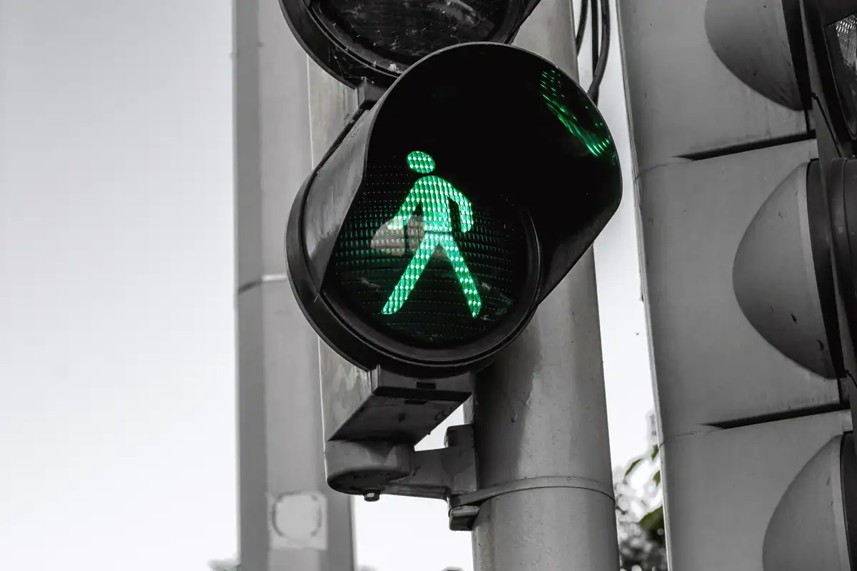 Green pedestrian crossing signal at an urban intersection