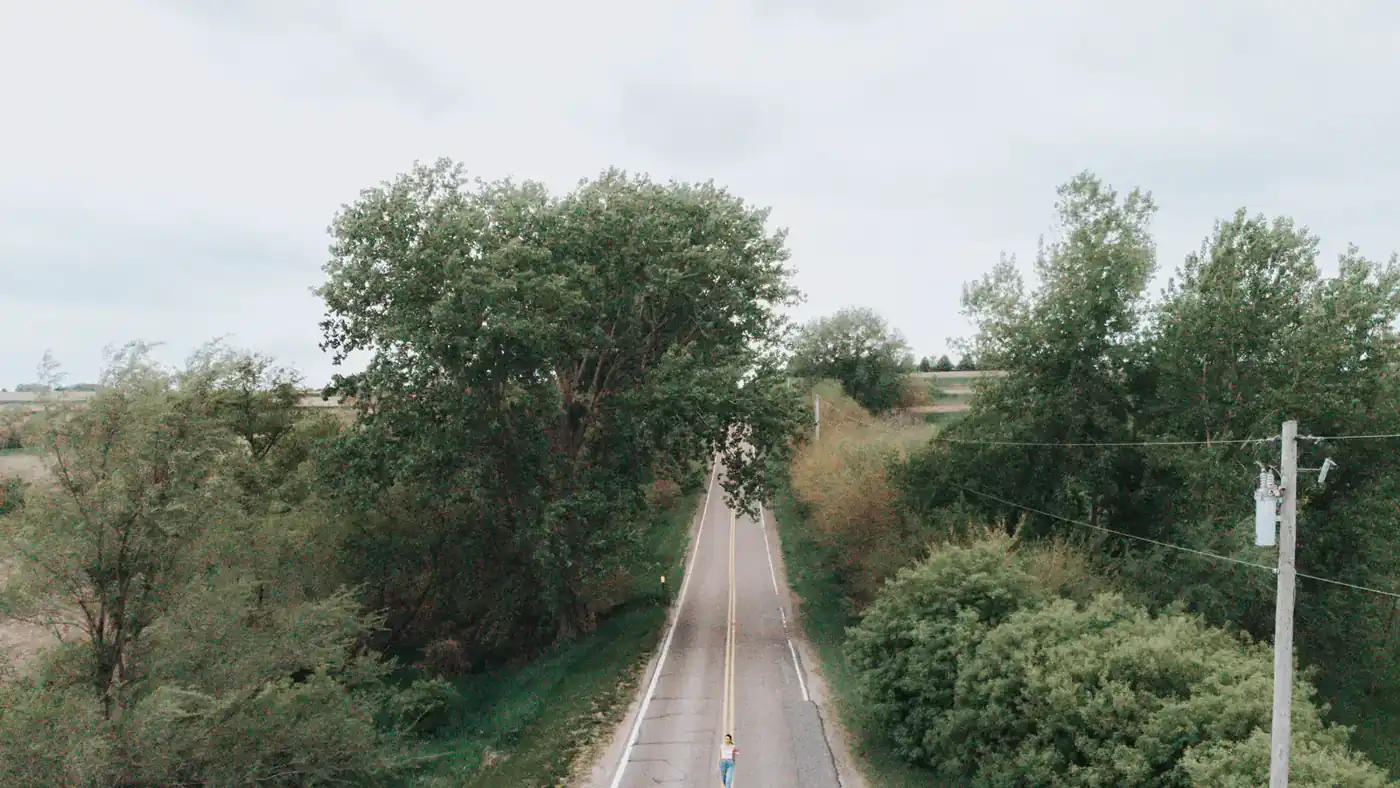 Aerial view of a person on a tree-lined road near Omaha, Nebraska